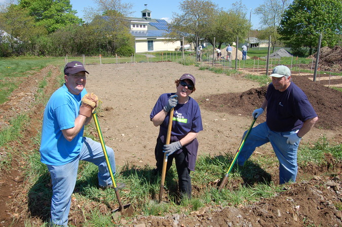 Kennebunk Savings volunteers dig a ditch